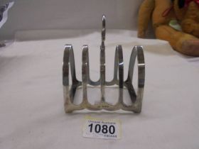 A hall marked silver toast rack.