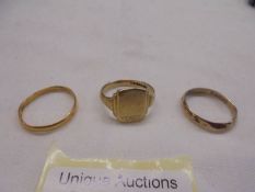 Two 9ct gold wedding rings and a 9ct gold signet ring, 6.14 grams.