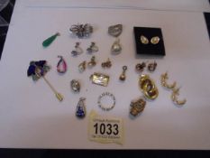 A mixed lot of earrings and charms including a silver butterfly.