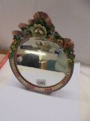 An floral framed dressing table mirror.