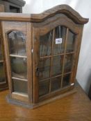 An oak glazed collector's display cabinet. COLLECT ONLY.