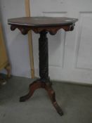 A dark oak octagonal tripod side table. COLLECT ONLY.