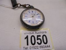 A ladies silver fob watch in need of attention.