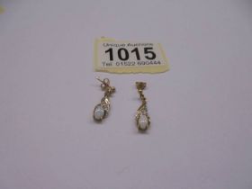 A pair of yellow gold and opal earrings, 1.65 grams.