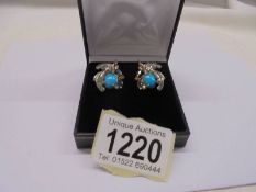 A pair of exotic bird earrings in silver gilt, set with cabachon turquoise, marquise-cut sapphires,