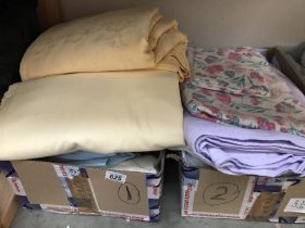 Two boxes of sheets and duvets