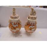 A pair of old Chinese lidded vases, badly a/f.