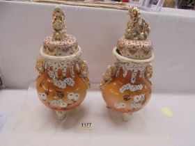 A pair of old Chinese lidded vases, badly a/f.