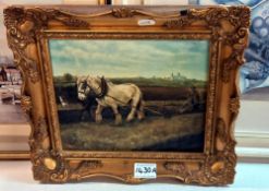 An oil on canvas of a farmer & horse ploughing a field in a gilt frame