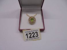 Vintage-styled 14ct yellow gold ornate oval pendant set with an oval peridot and several RBC