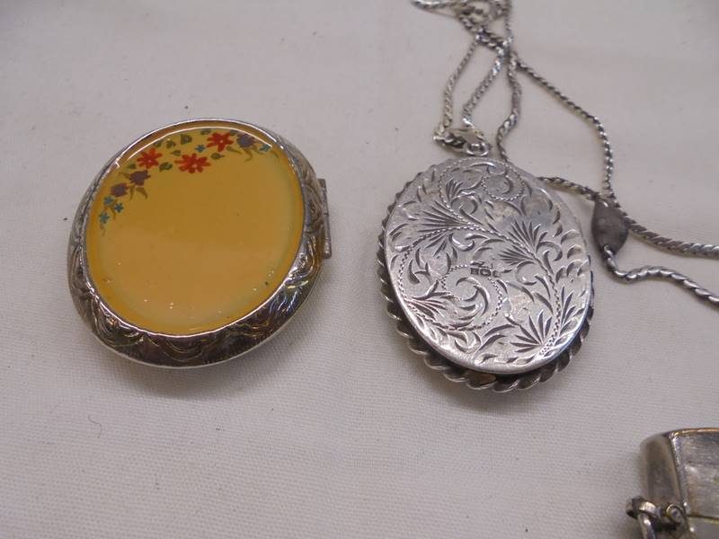 A silver locket, two white metal lockets and a miniature cigarette lighter. - Image 4 of 5