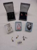 Six pairs of pendant earrings and three odds.