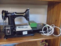 A Singer Featherweight 222K sewing machine with accessories (no case).