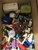 A quantity of sewing items including sewing machine feet, buttons, pins etc