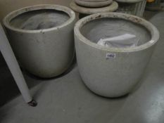 A pair of composite garden planters, 43 cm high x 43 cm diameter. COLLECT ONLY.