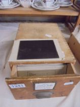 A collection of c. 84 glass and celluloid negatives housed in a wooden box,