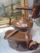 A copper kettlle and cased binoculars.