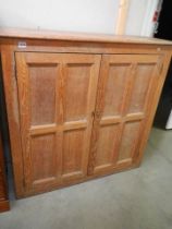 A Victorian oak school cupboard with three shelves (later back), 123 cm tall x 125 cm wide x 42 cm d