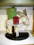 A rare novelty tin place cigarette dispenser of a donkey.