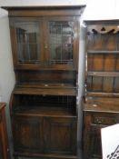 An oak roll top bureau bookcase with leaded glass panels. COLLECT ONLY.