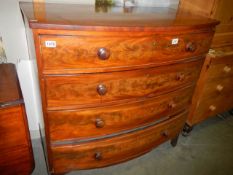A 19th century bow fronted mahogany four drawer chest on bracket feet with turned wood knobs