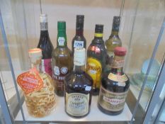 A bottle of cherry brandy, Drambuie, White port, Gin Liqueur, Kahlua and three other bottles,