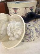 2 ornate hat boxes with hat and fascinator