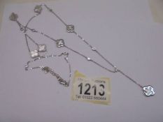 Long silver necklace alternately set with mother of pearl and white round cubic zirconia