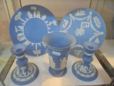 Five pieces of Wedgwood Jasper ware including a pair of candlesticks, plates etc.,