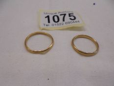 Two 22 ct gold wedding rings, sizes N and Q half, 4.8 grams.