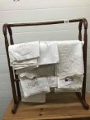 Antique wooden towel rail with quantity of table cloths