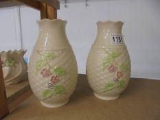 A pair of unboxed Belleek vases.