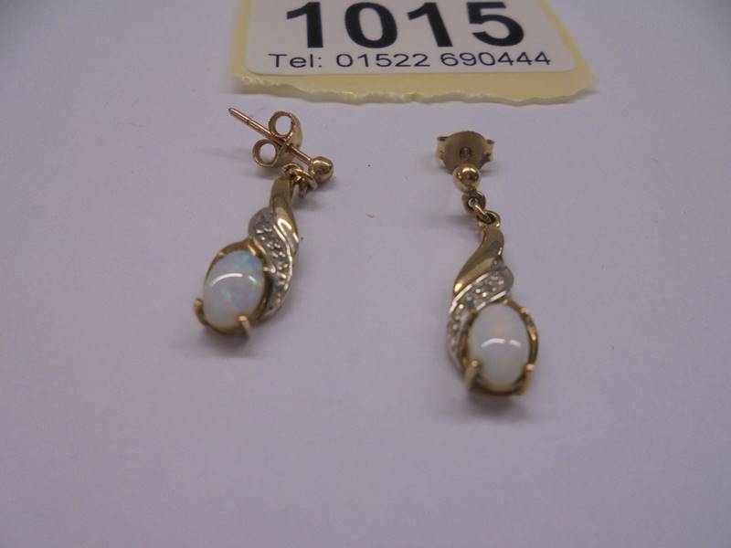 A pair of yellow gold and opal earrings, 1.65 grams. - Image 2 of 2