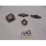 Three vintage silver brooches and a silver fob.