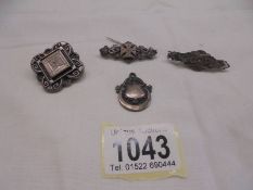 Three vintage silver brooches and a silver fob.