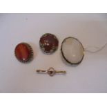 A 19th century stone set brooch, an agate brooch, a 9ct gold brooch set amethyst and another brooch