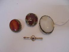 A 19th century stone set brooch, an agate brooch, a 9ct gold brooch set amethyst and another brooch