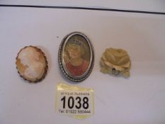 An old cameo of a young woman, an oil miniature of a woman and a carved bone antique brooch,.