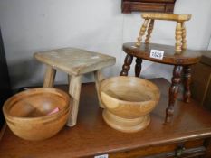 A small burr walnut stool, two other stools and two wooden bowls.