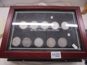 A collection of ten Morgan silver dollars in case, 1879, 1882, 1891, 1899, 1921 - 1926.