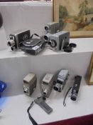 A collection of vintage cine cameras.