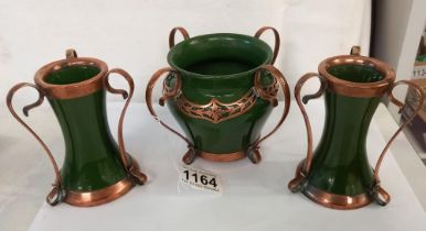 A pair of Art Nouveau copper bound vases and a similar bowl by H W Ltd., (possibly Hugh Wallis)