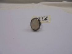 Oval cabochon moonstone and rose-cut diamond ring. Moonstone 7.95ct. Diamonds 0.37ct