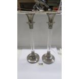 A pair of tall contemporary candlesticks.