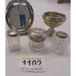 A small silver footed dish (dinted), three silver topped pots and a white metal photo frame.