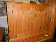 A small pine cupboard with adjustable shelf, 76H x 96W x 32D. COLLECT ONLY.