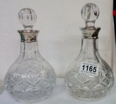 A pair of superb quality silver mounted cut glass decanters, 20 cm tall.
