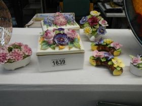 A collection of floral items including trinket boxes.