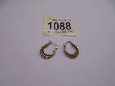 A pair of 9ct rose, white and yellow gold three hoop earrings.