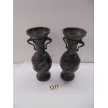 A pair of bronze vases with applied dragons, 17 cm tall.